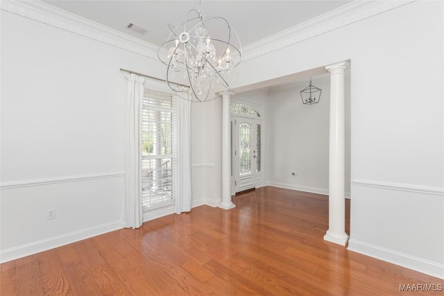 1580 W Overbrook Rd, Millbrook, AL 36054 - unfurnished dining area with an inviting chandelier, visible vents, wood finished floors, and ornamental molding