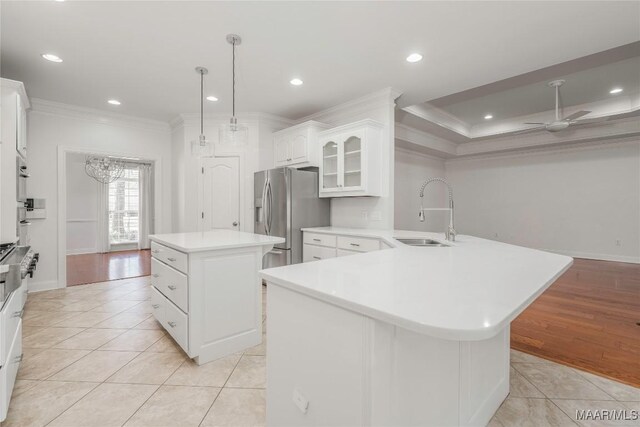1580 W Overbrook Rd, Millbrook, AL 36054 - kitchen with a center island, a sink, stainless steel refrigerator with ice dispenser, light countertops, and ornamental molding