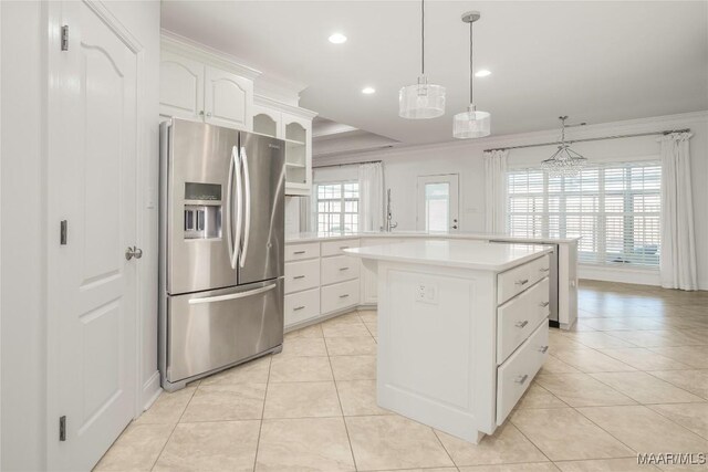 1580 W Overbrook Rd, Millbrook, AL 36054 - kitchen with stainless steel refrigerator with ice dispenser, a wealth of natural light, light countertops, a center island, and light tile patterned floors