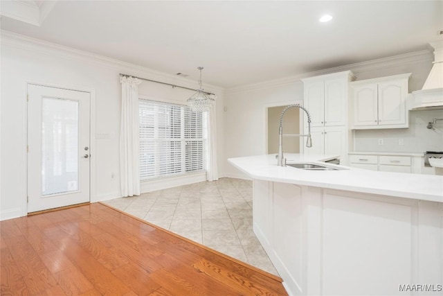 1580 W Overbrook Rd, Millbrook, AL 36054 - kitchen with custom exhaust hood, a sink, white cabinetry, crown molding, and light countertops