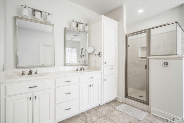 1580 W Overbrook Rd, Millbrook, AL 36054 - bathroom featuring a stall shower, tile patterned floors, double vanity, and a sink