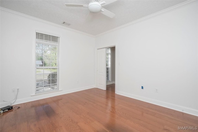 1580 W Overbrook Rd, Millbrook, AL 36054 - empty room featuring crown molding, visible vents, wood finished floors, and ceiling fan