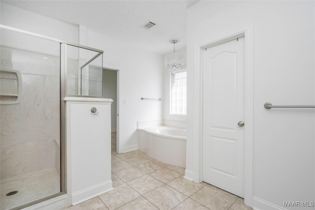 1580 W Overbrook Rd, Millbrook, AL 36054 - bathroom with a shower stall, a garden tub, a chandelier, and visible vents