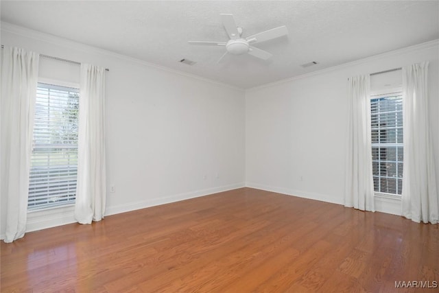 1580 W Overbrook Rd, Millbrook, AL 36054 - unfurnished room with crown molding, visible vents, wood finished floors, and ceiling fan