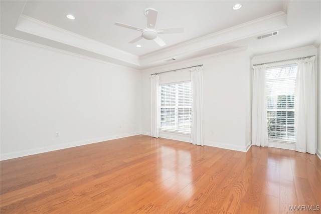 1580 W Overbrook Rd, Millbrook, AL 36054 - unfurnished room featuring light wood-style flooring, a tray ceiling, visible vents, ceiling fan, and ornamental molding