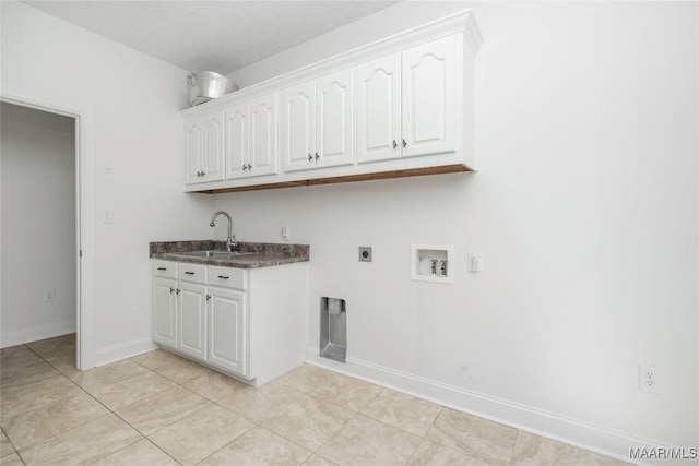 1580 W Overbrook Rd, Millbrook, AL 36054 - washroom featuring a sink, cabinet space, hookup for an electric dryer, light tile patterned floors, and washer hookup