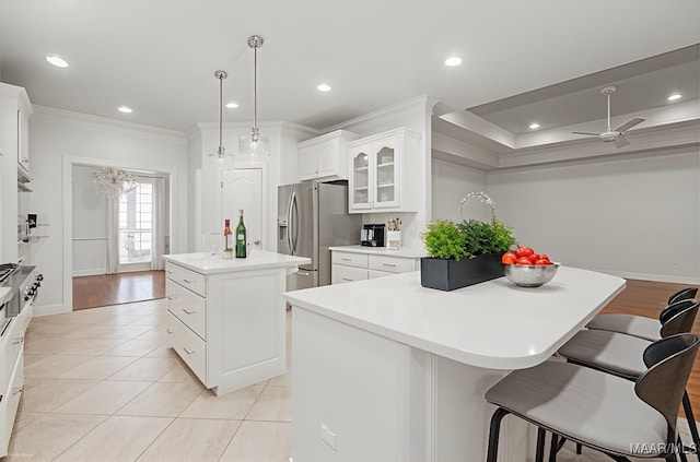 1580 W Overbrook Rd, Millbrook, AL 36054 - kitchen with stainless steel fridge, glass insert cabinets, a kitchen breakfast bar, crown molding, and a kitchen island
