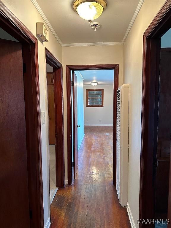 125 Butler St, Selma, AL 36701 - corridor with dark wood-style floors, baseboards, crown molding, and a heating unit