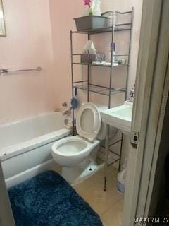 bathroom featuring toilet, tile patterned floors, and shower / bathing tub combination