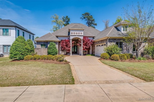 9533 Fendall Hall Cir, Montgomery, AL 36117 - view of front of property featuring stone siding, a garage, a front lawn, and concrete driveway