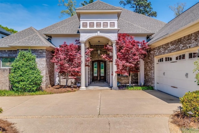 9533 Fendall Hall Cir, Montgomery, AL 36117 - entrance to property with stucco siding, roof with shingles, an attached garage, french doors, and driveway