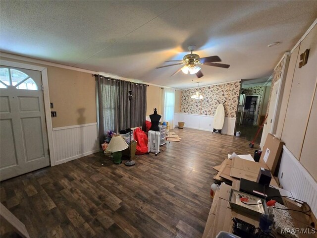 foyer featuring a wainscoted wall, ceiling fan, wallpapered walls, and plenty of natural light