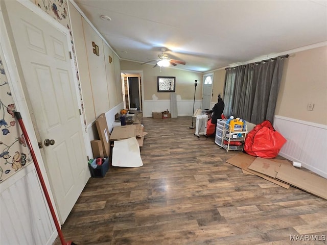 interior space with wood finished floors, crown molding, ceiling fan, and wainscoting