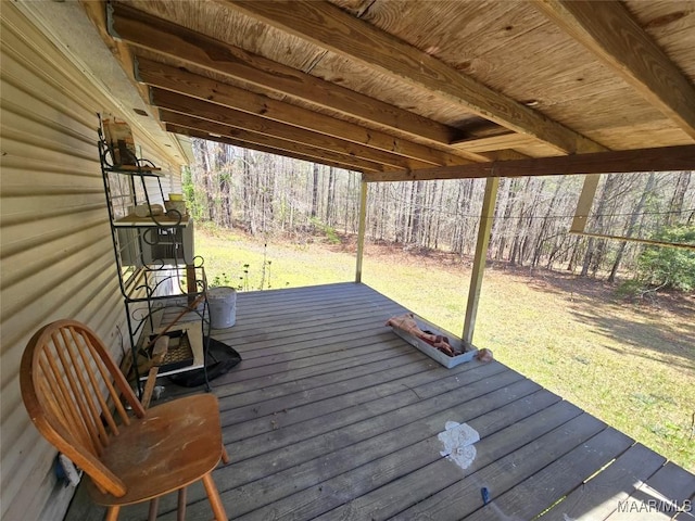 wooden terrace featuring a lawn