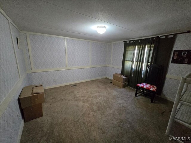 interior space with baseboards, wallpapered walls, and a textured ceiling