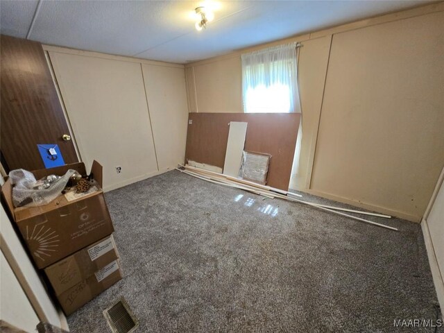 unfurnished bedroom featuring carpet and visible vents