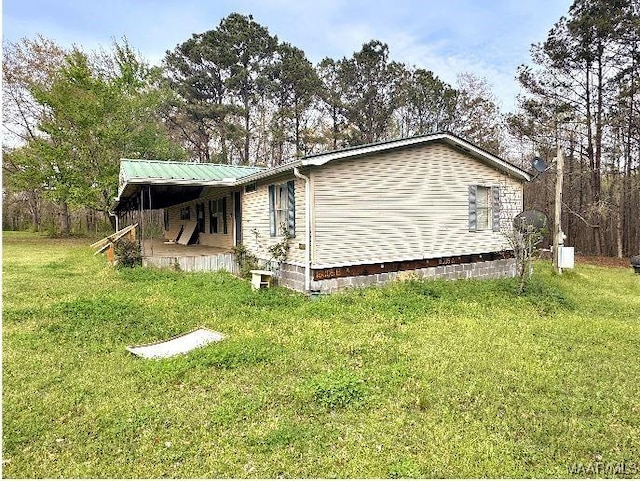 view of side of property with a lawn