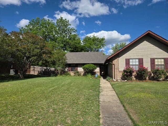 ranch-style home with a front lawn and brick siding