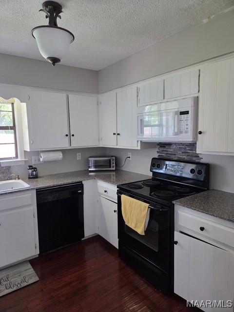 kitchen with white cabinets, a textured ceiling, black appliances, and dark wood-style floors