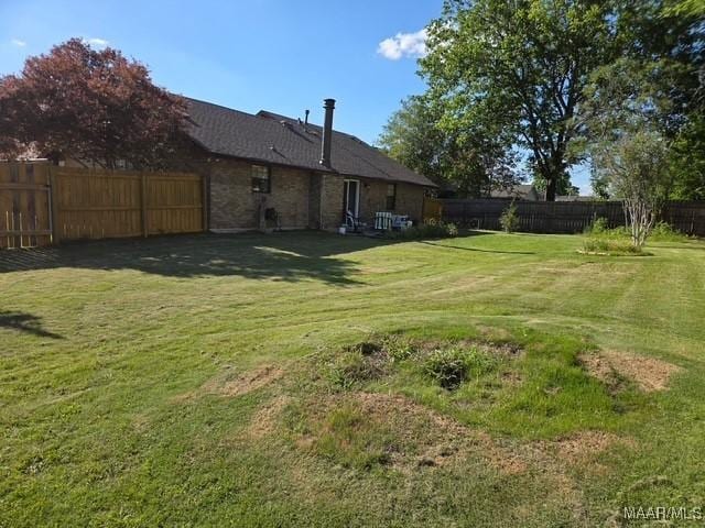 view of yard with a fenced backyard