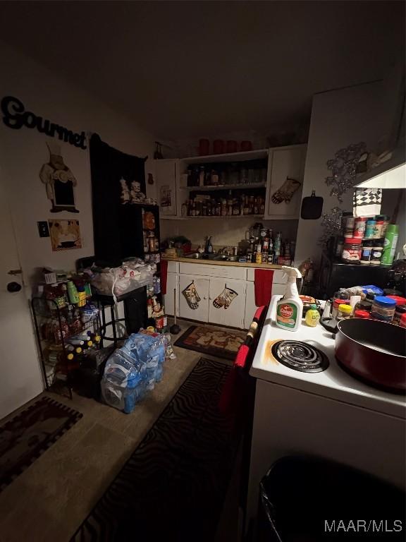 kitchen featuring white electric stove and a sink