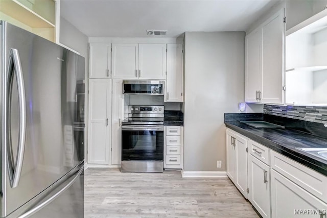 kitchen featuring visible vents, white cabinets, open shelves, dark countertops, and appliances with stainless steel finishes