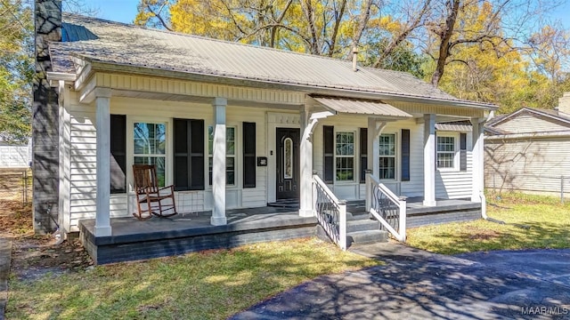 bungalow featuring metal roof and covered porch
