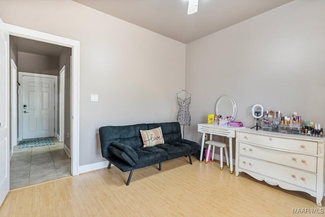 sitting room featuring baseboards and light wood-style flooring
