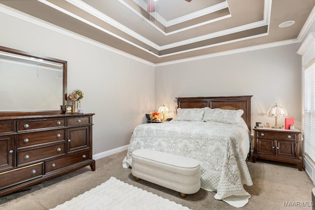 bedroom with crown molding, baseboards, ceiling fan, light colored carpet, and a tray ceiling