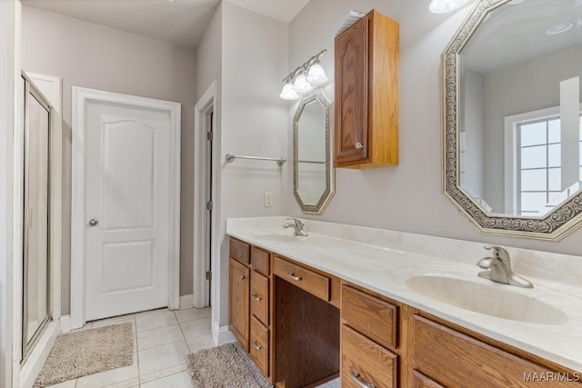 bathroom with double vanity, a sink, tile patterned floors, and a stall shower