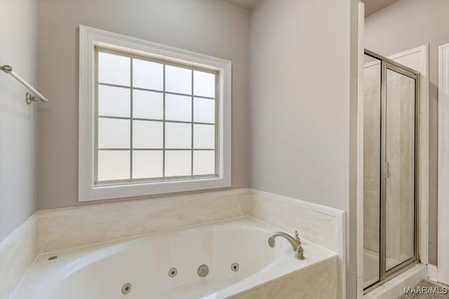 full bath featuring a jetted tub and a stall shower