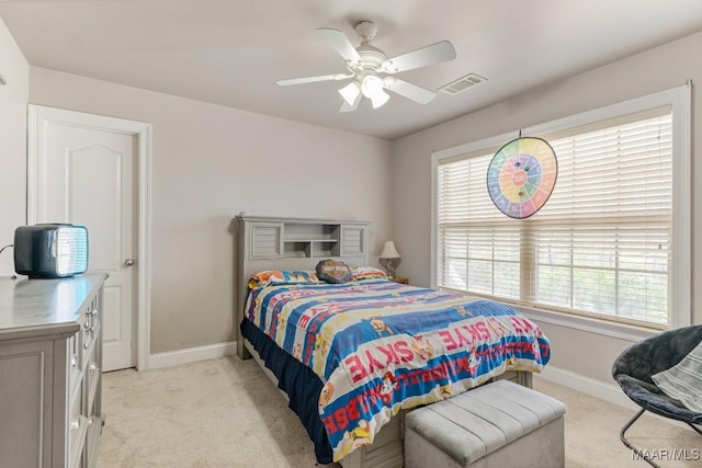 bedroom featuring baseboards, visible vents, and light colored carpet