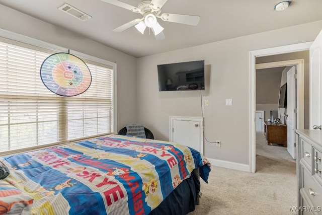 bedroom featuring baseboards, ceiling fan, light carpet, and visible vents