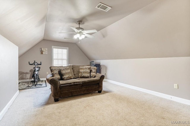 carpeted living area featuring baseboards, visible vents, ceiling fan, and vaulted ceiling