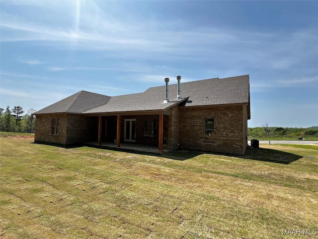 228 Mountain Laurel Rdg, Wetumpka, AL 36093 - rear view of house with a lawn, brick siding, a patio, and a shingled roof