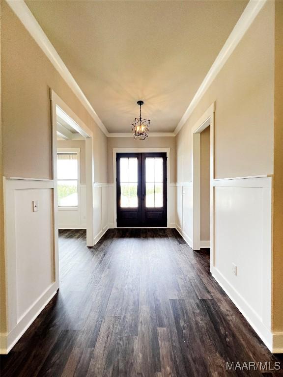 228 Mountain Laurel Rdg, Wetumpka, AL 36093 - doorway to outside with dark wood-style flooring, an inviting chandelier, a wainscoted wall, french doors, and ornamental molding
