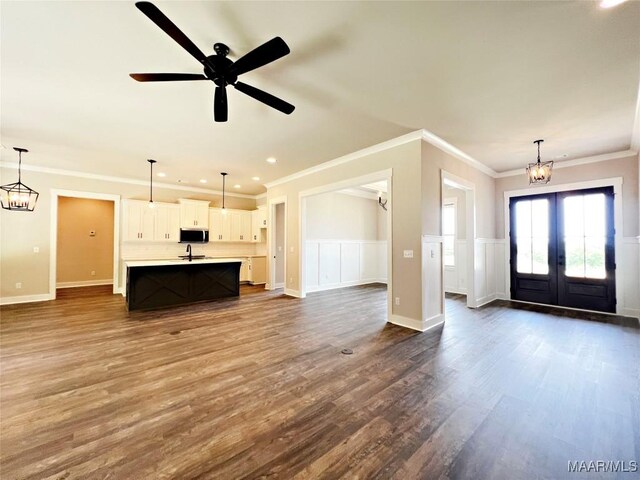 228 Mountain Laurel Rdg, Wetumpka, AL 36093 - unfurnished living room with recessed lighting, ornamental molding, french doors, dark wood-type flooring, and wainscoting
