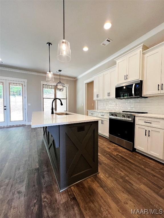 228 Mountain Laurel Rdg, Wetumpka, AL 36093 - kitchen with a sink, stainless steel appliances, light countertops, dark wood-type flooring, and visible vents