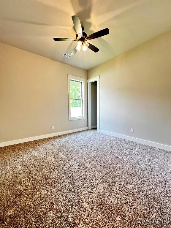 228 Mountain Laurel Rdg, Wetumpka, AL 36093 - carpeted empty room featuring visible vents, a ceiling fan, and baseboards