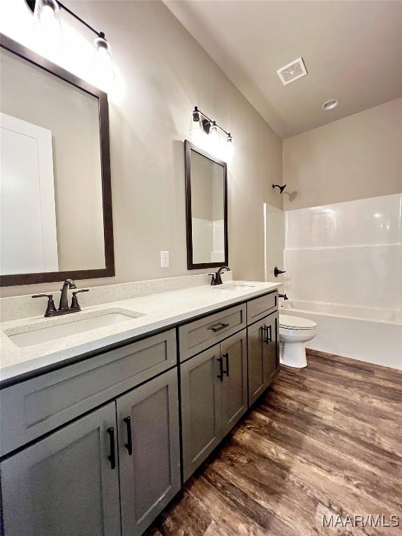 228 Mountain Laurel Rdg, Wetumpka, AL 36093 - bathroom with wood finished floors, visible vents, toilet, and a sink
