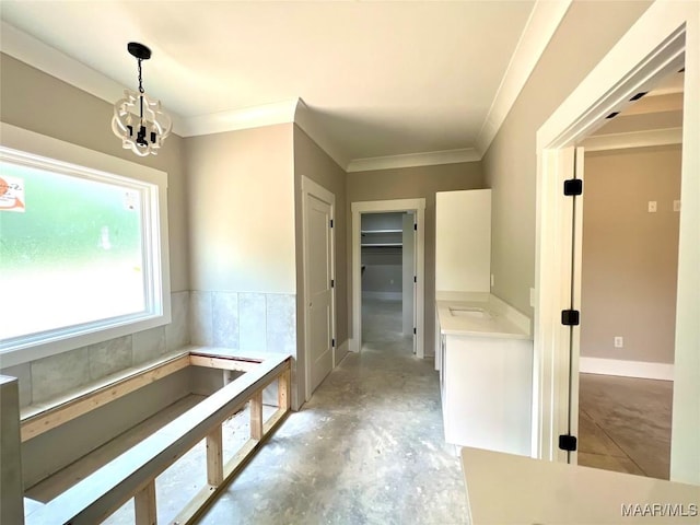 1150 Southern Hills Dr, Wetumpka, AL 36093 - hall with concrete floors, a chandelier, and ornamental molding