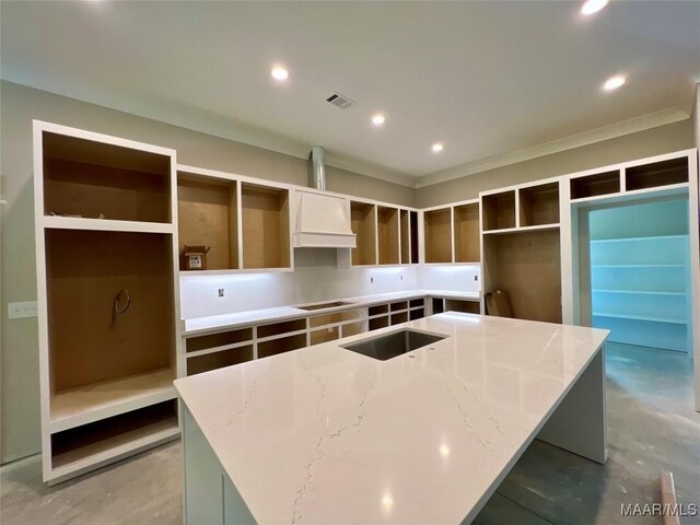 1150 Southern Hills Dr, Wetumpka, AL 36093 - kitchen featuring an island with sink, concrete flooring, custom range hood, light stone countertops, and recessed lighting