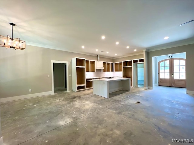 1150 Southern Hills Dr, Wetumpka, AL 36093 - kitchen with ornamental molding, a kitchen island, a chandelier, french doors, and concrete flooring