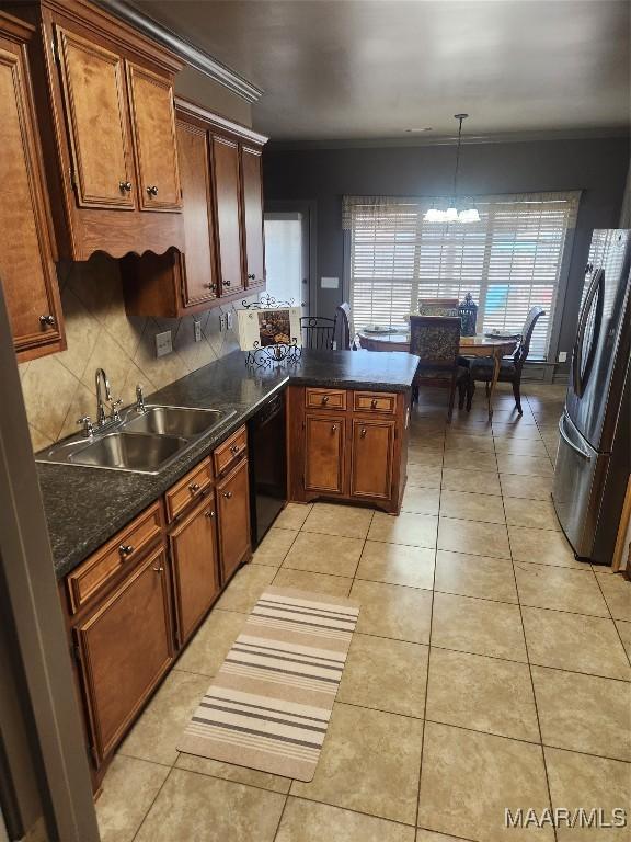 103 Rushmore Ct, Deatsville, AL 36022 - kitchen featuring decorative backsplash, a chandelier, dishwasher, a sink, and freestanding refrigerator