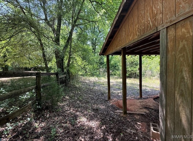 view of yard with fence and a wooded view