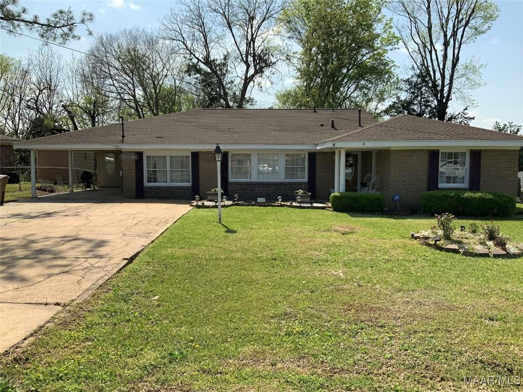 3007 Summerfield Rd, Selma, AL 36701 - single story home with a front lawn, driveway, an attached carport, and brick siding