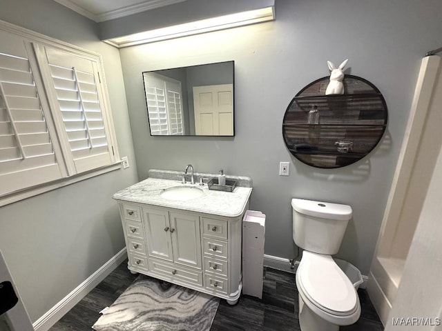 2714 County Road 54, Ozark, AL 36360 - bathroom featuring baseboards, wood finished floors, toilet, and vanity