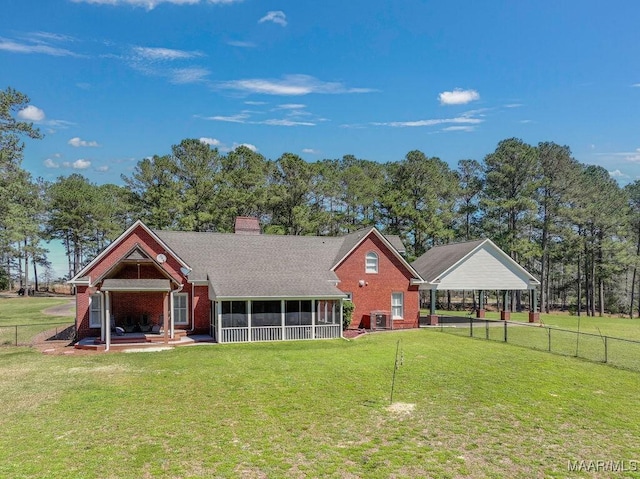 2714 County Road 54, Ozark, AL 36360 - back of house featuring a sunroom, fence, central AC unit, a yard, and a chimney