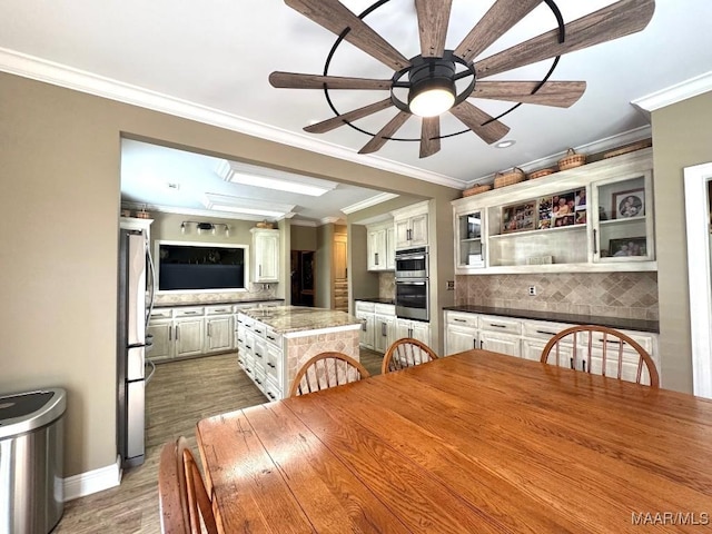 2714 County Road 54, Ozark, AL 36360 - dining space with a ceiling fan, ornamental molding, baseboards, and wood finished floors