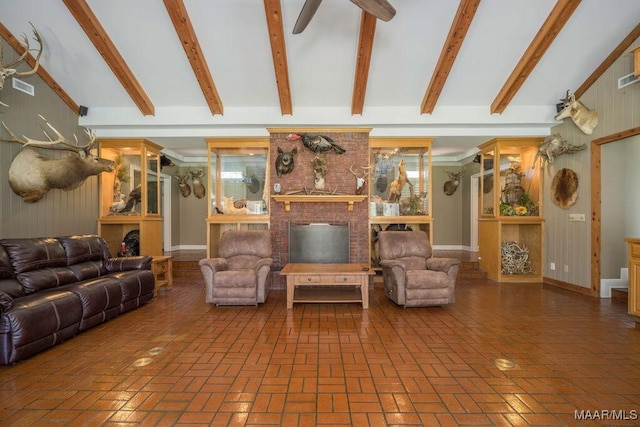 2714 County Road 54, Ozark, AL 36360 - living area featuring a fireplace, lofted ceiling with beams, brick floor, and a ceiling fan